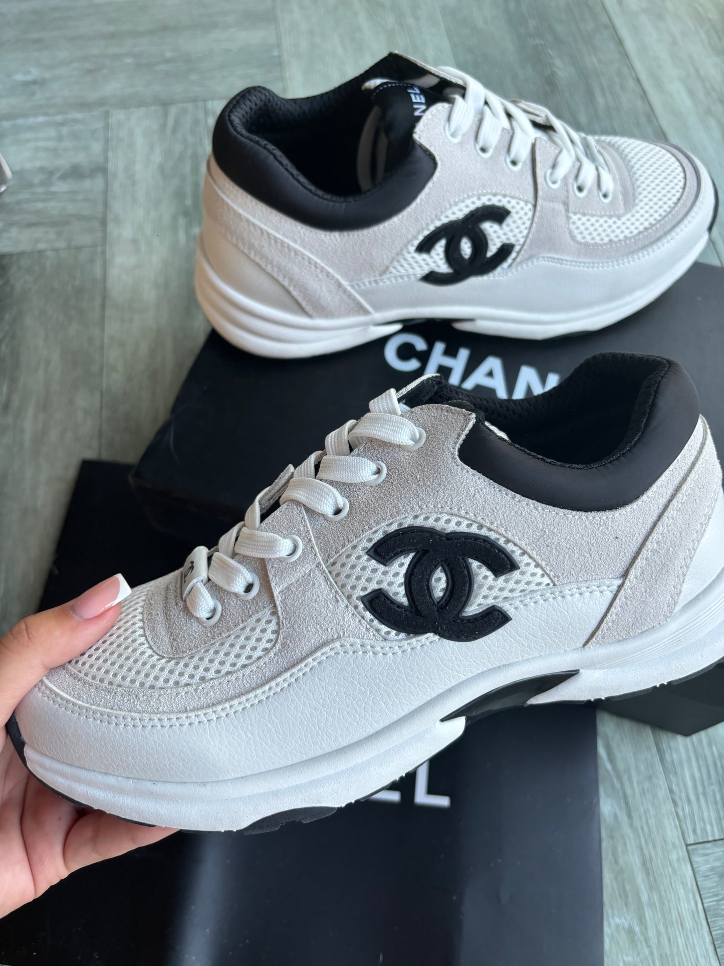 Beige and black cc trainers