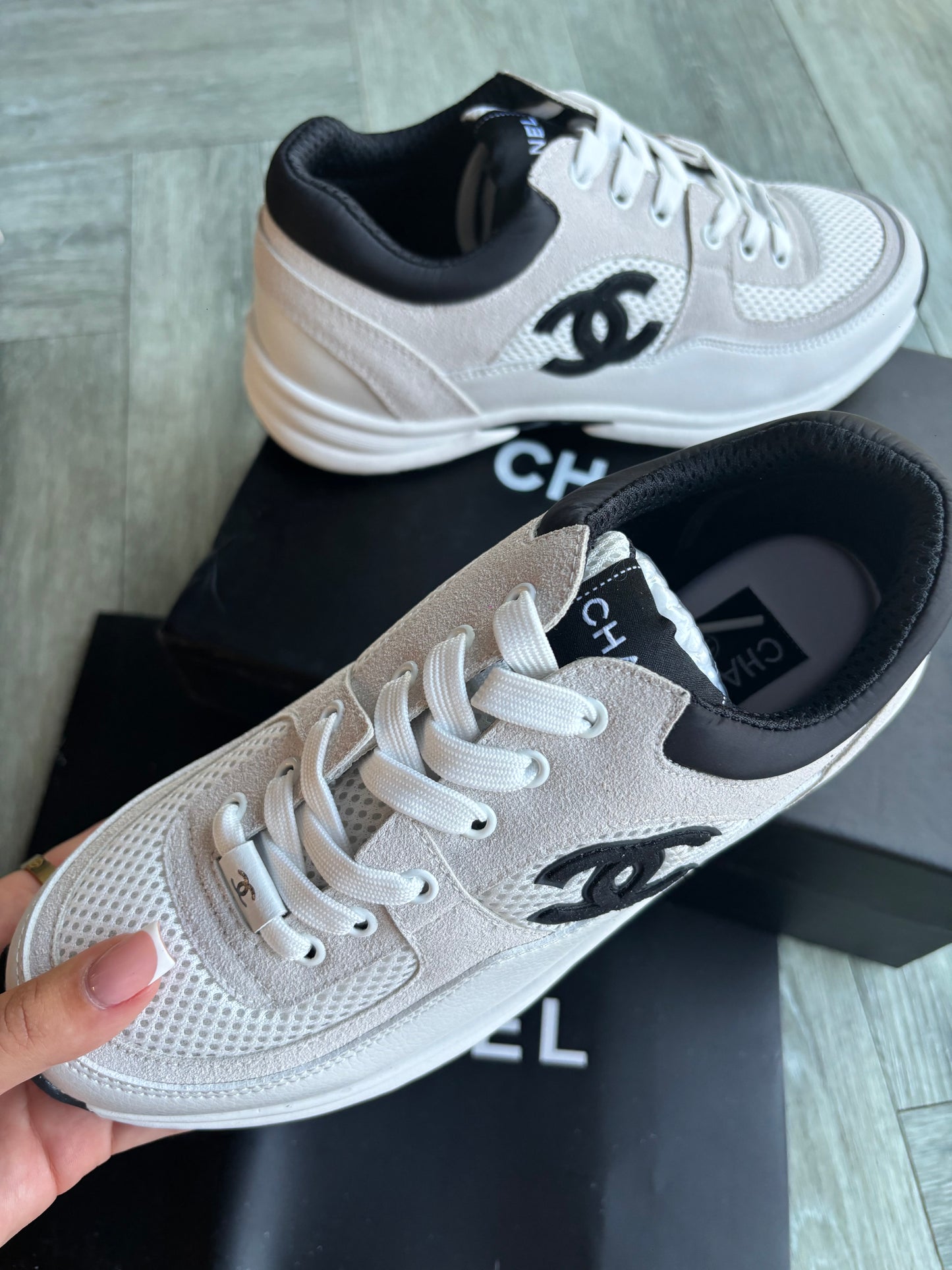 Beige and black cc trainers