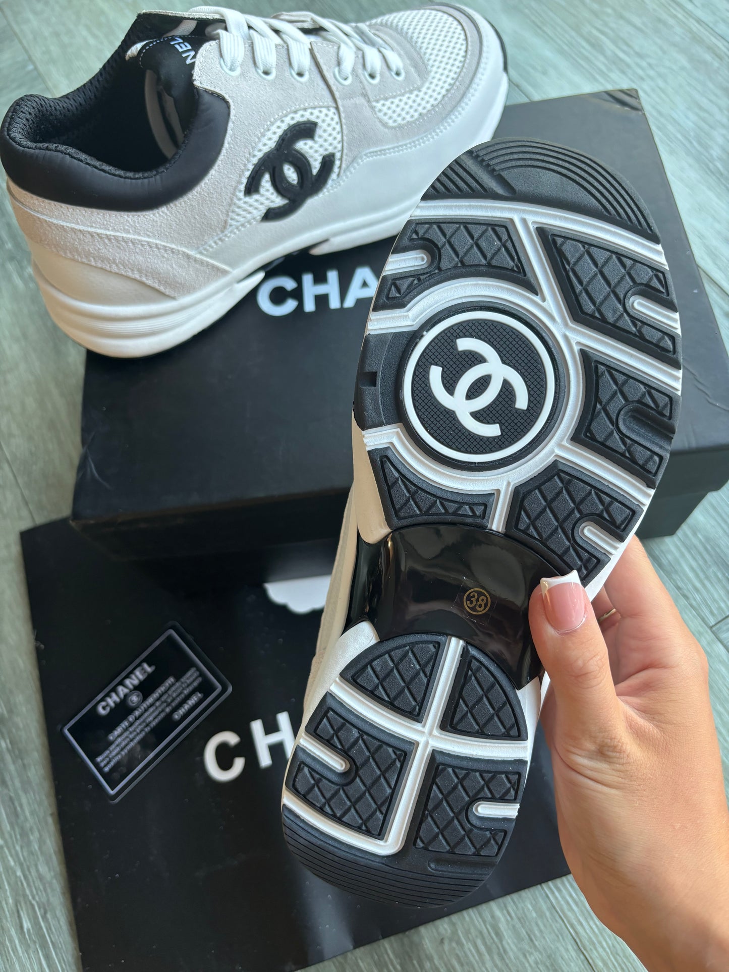 Beige and black cc trainers