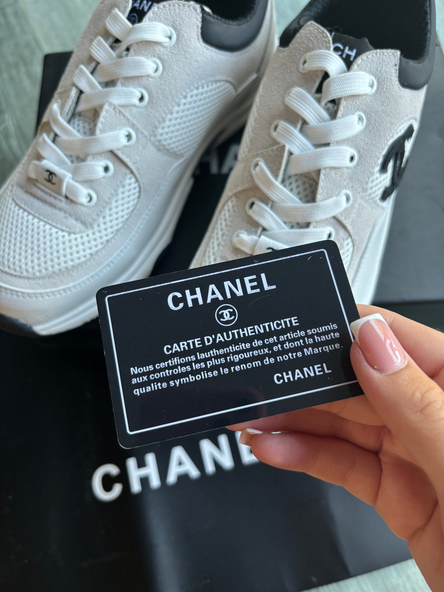 Beige and black cc trainers