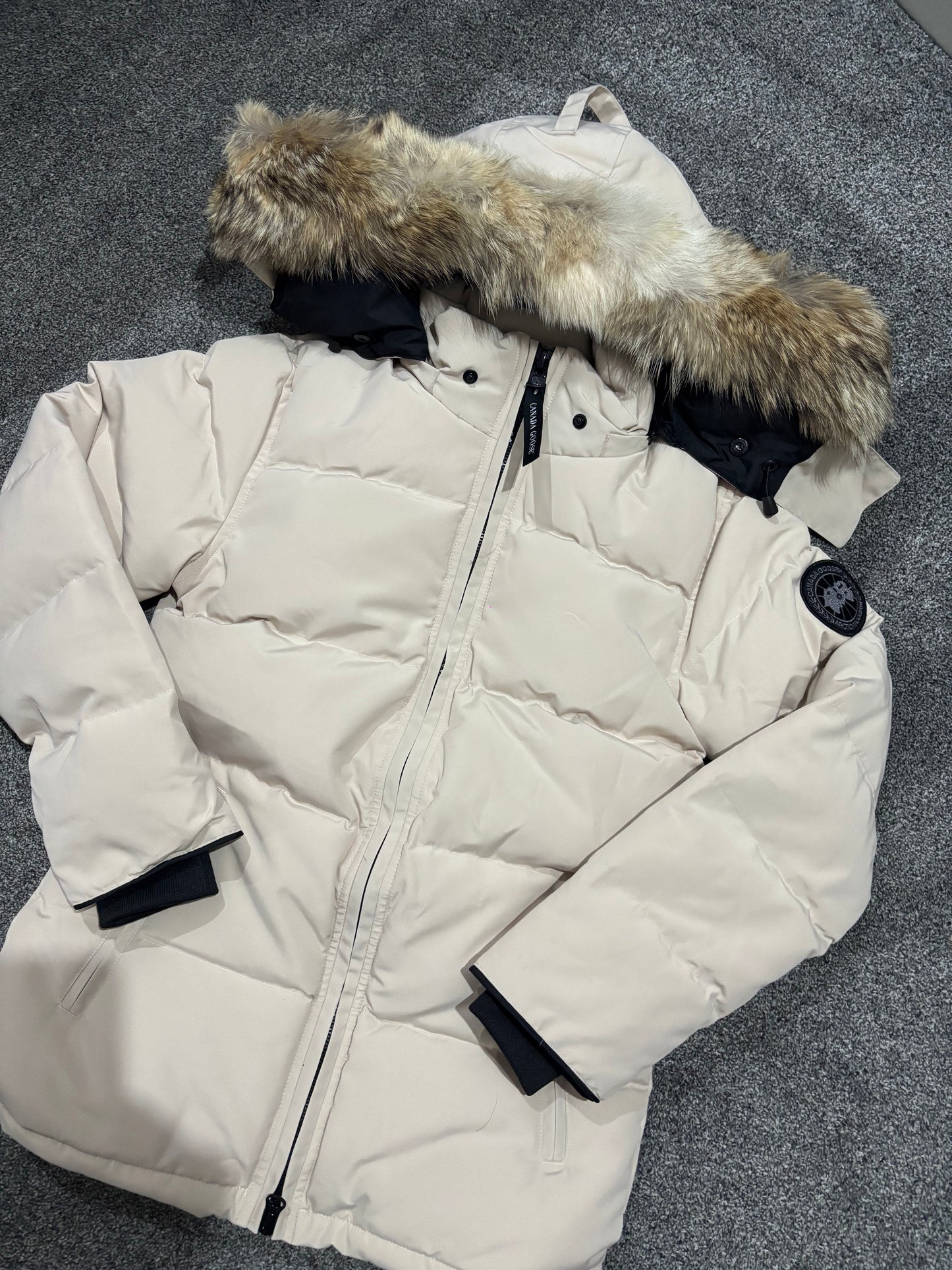 Beige Canada coat with black badge, fox fur