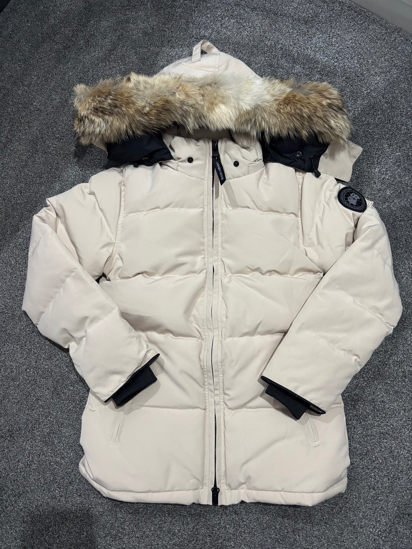 Beige Canada coat with black badge, fox fur