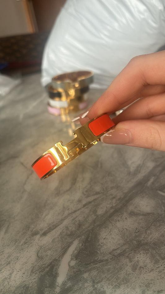Orange and gold h bracelets
